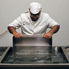 Photo: placing a pressing box in the cooling tank